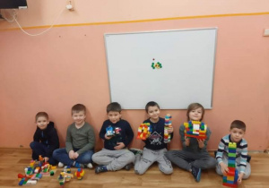 Chłopcy pozują z budowlami wykonanymi z klocków lego